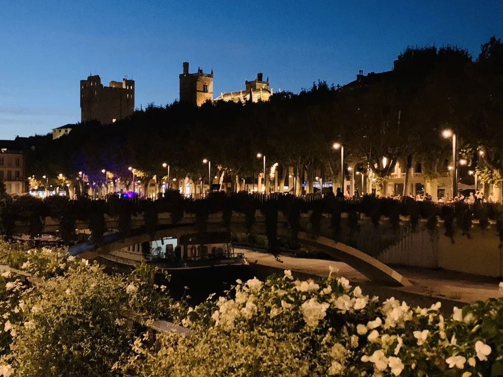 Narbonne in der blauen Stunde: die beleuchtete Kathedrale über dem Kanal